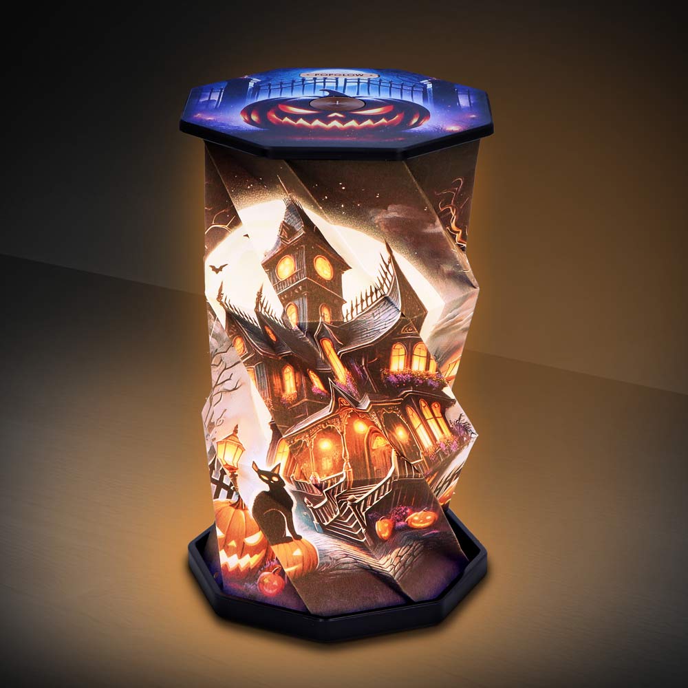 Halloween-themed decorative lantern featuring a haunted house, pumpkins, and a black cat with a warm amber glow.
