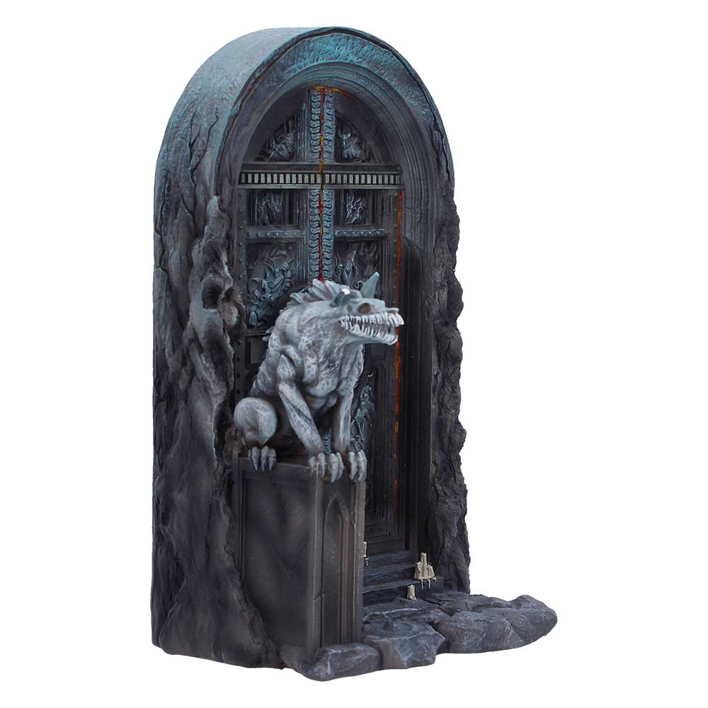Grey dragon statue perched on a stone pedestal before a dark iron door set in a rocky archwayscape.
