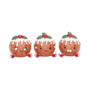 Three cute Christmas pudding figurines with white icing drizzle and holly on top, smiling and sitting in a row with red shoes on white background