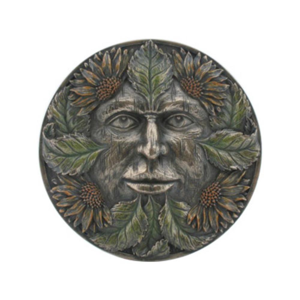 Round metal medallion with a carved human face framed by a wreath of leaves and sunflower blossoms in relief