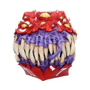 Colorful monster head sculpture with red and purple textures and many large ivory teeth, decorative art piece.