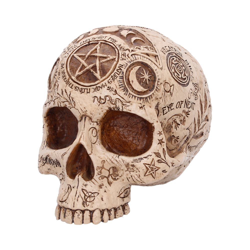 Decorative skull sculpture covered in occult symbols and inscriptions.