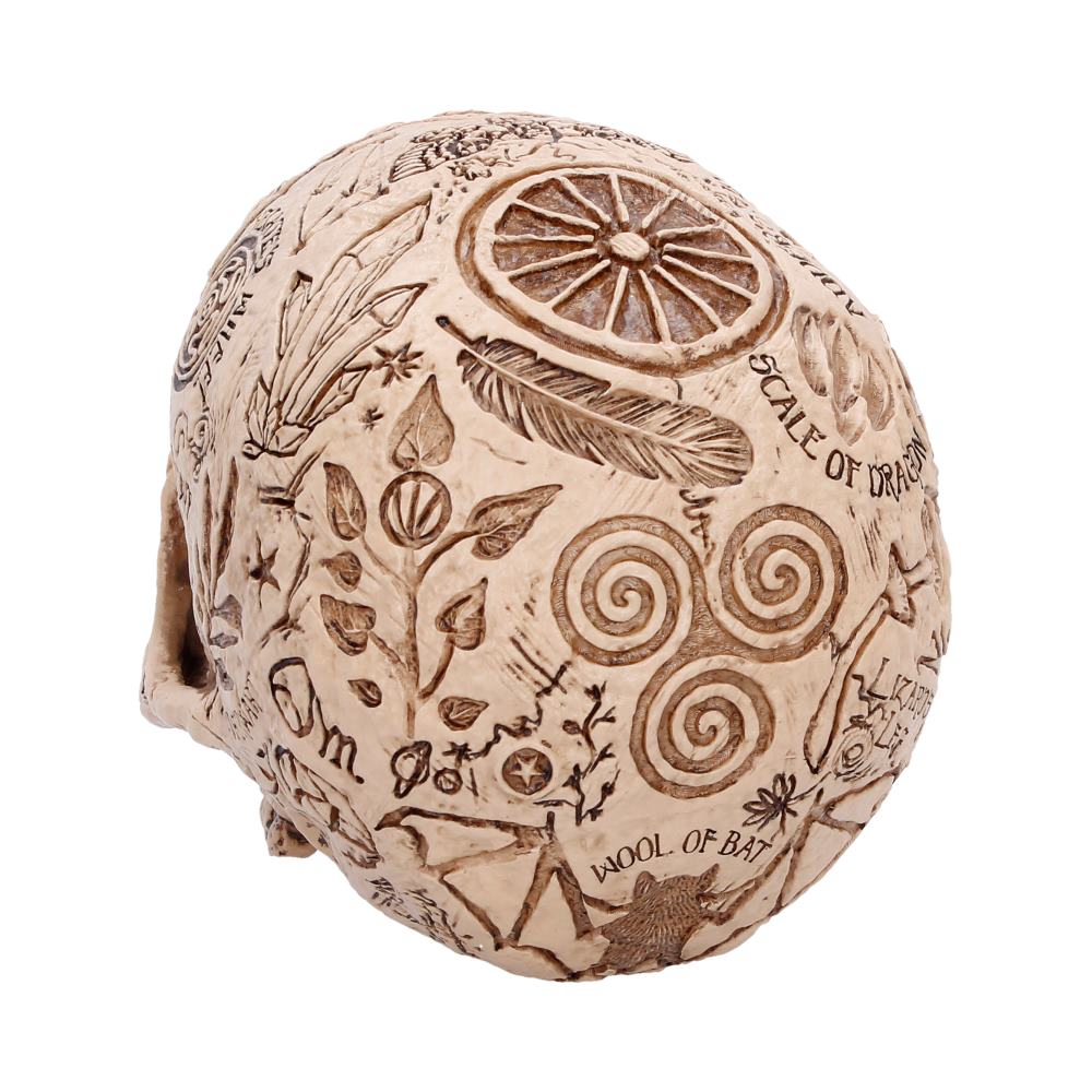 Decorative carved sphere with botanical and symbolic engravings, showing spirals and wheel motifs.