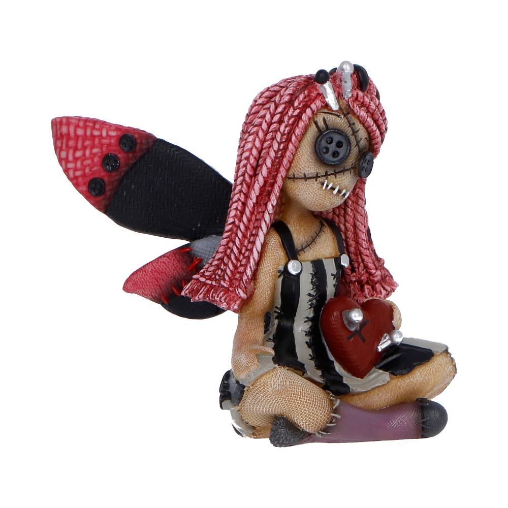 Sewn plush doll with pink yarn hair, striped dress, sitting and holding a red heart.