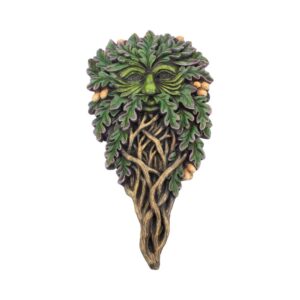 Whimsical tree-face sculpture with green leaves forming a face and twisting roots underneath