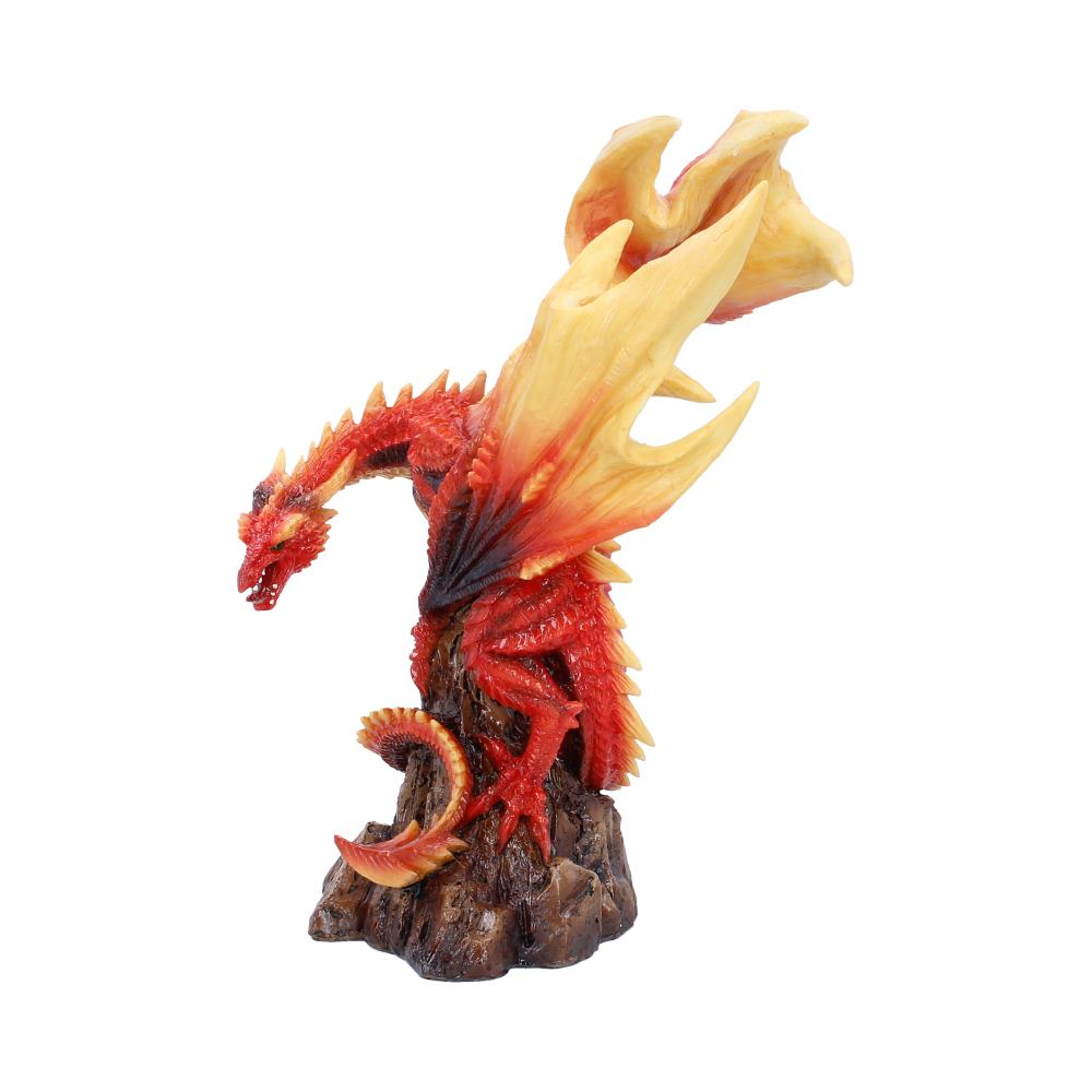 Red dragon figurine with orange-yellow flaming wings perched on a rocky pedestal.