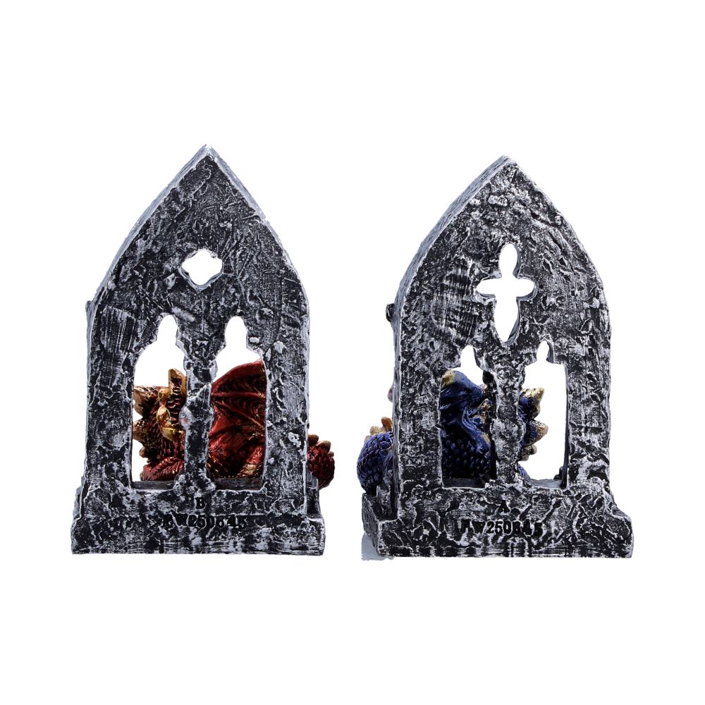 Pair of small stone church-shaped bookends with red and blue decorative beads inside the openings