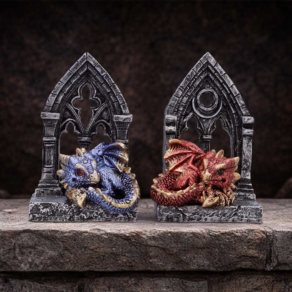 Two dragon figurines resting in stone Gothic arches, blue dragon on left, red dragon on right.