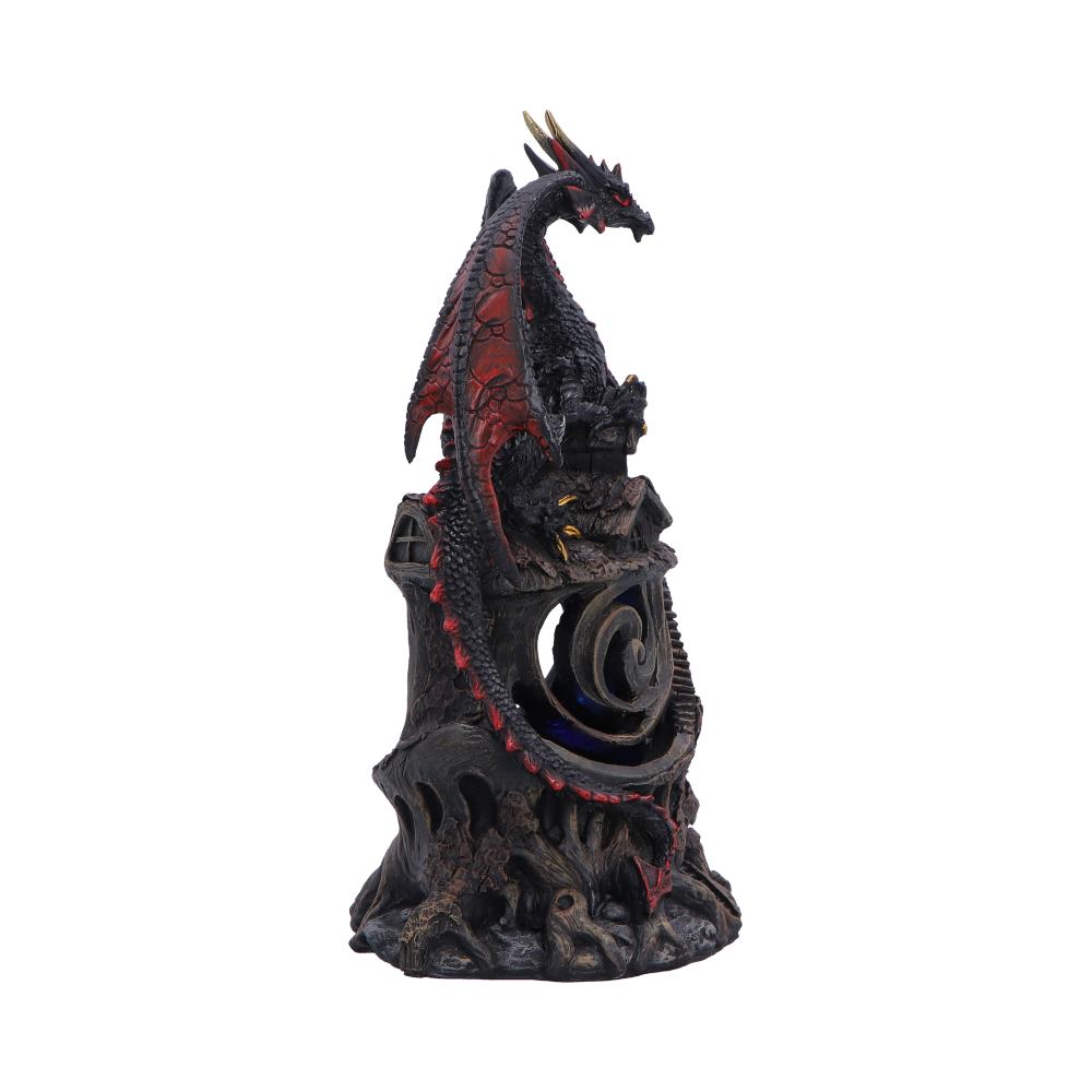 Dragon figurine perched on a jagged rocky pedestal with a circular portal, red and black scales visible