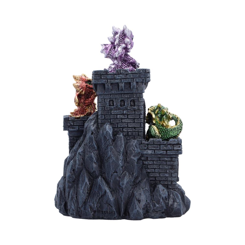 Colorful dragon-themed castle sculpture with purple, red/gold, and green dragons perched on a dark rock tower.